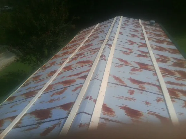 Rusted metal roof panels with new wood purlins before replacement — Storm Damage Roof Repair in River Rouge by Roofing Brothers
