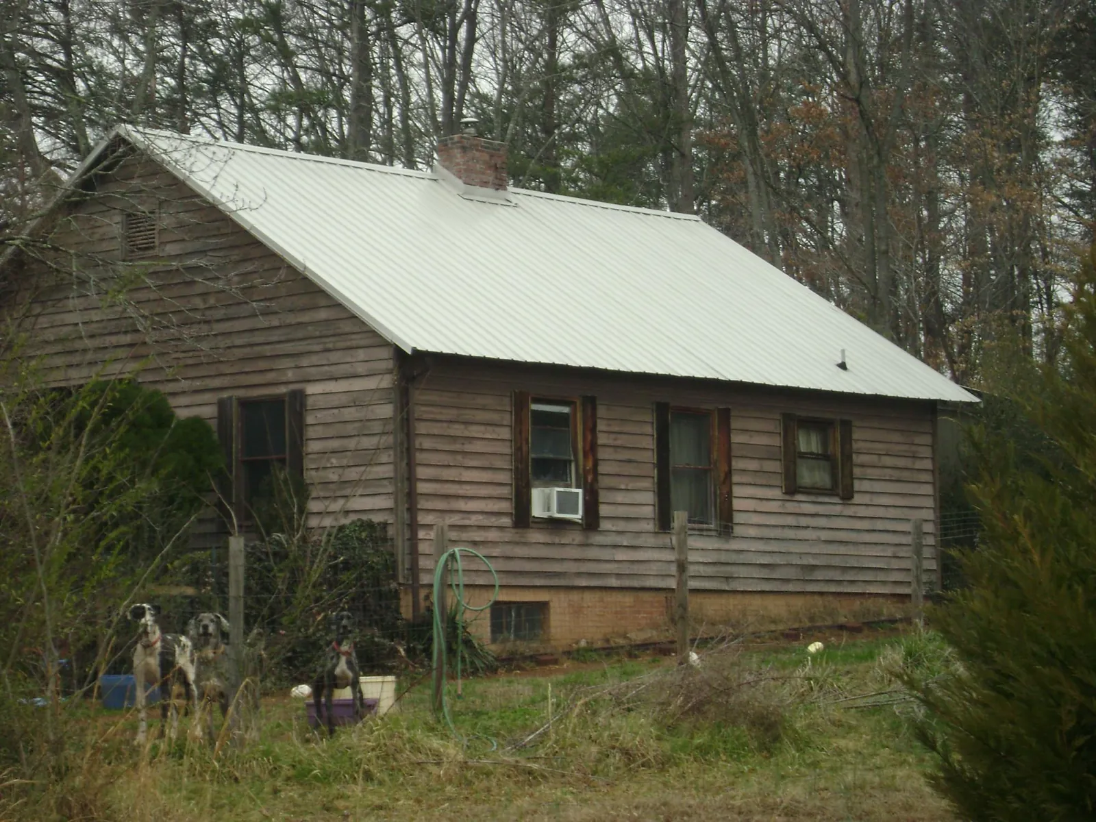 White metal roof on an old wood sided farmhouse, from a Metal Roof Installation job in River Rouge